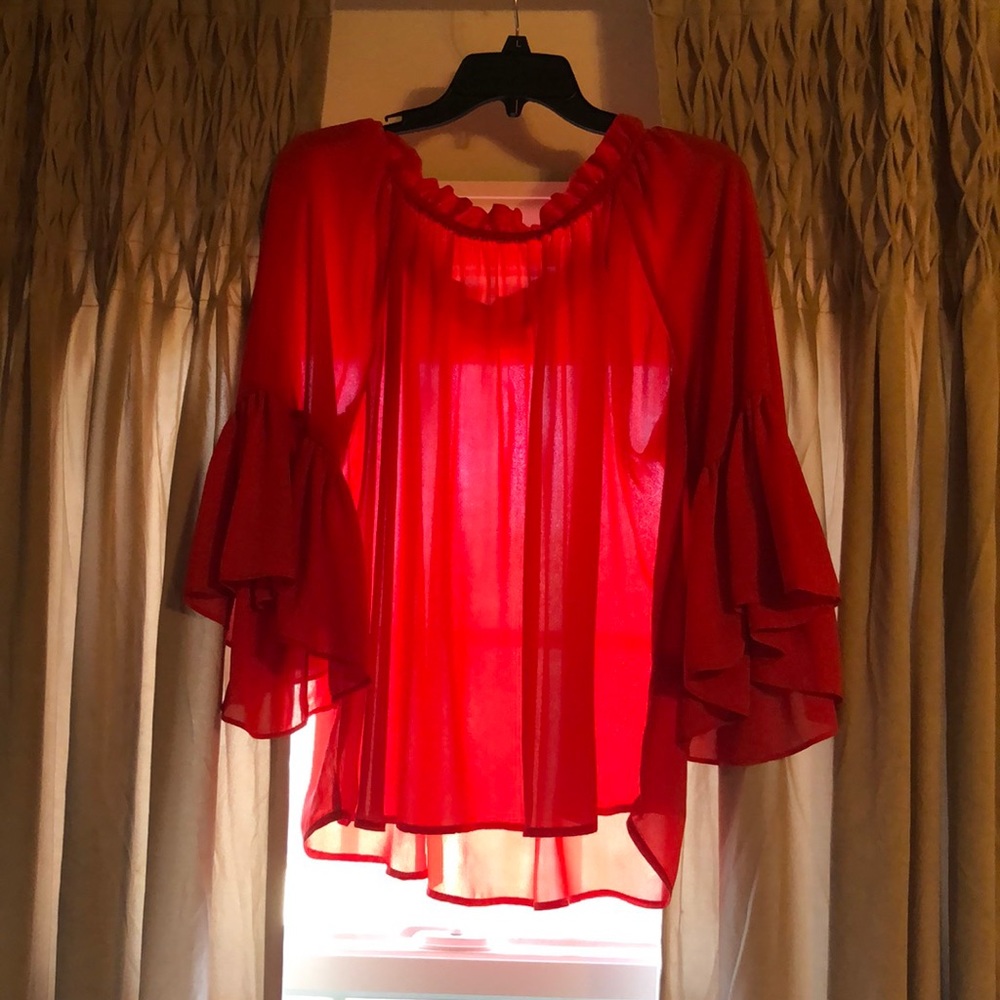 GORGEOUS orange blouse.